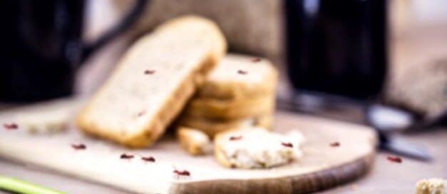 Close up of ants crawling across bread on table