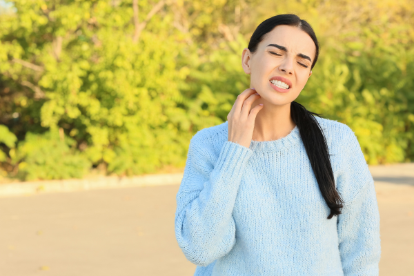 Woman scratching her neck.